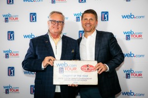 PCCC Executive Director Jerald Andrews accepts the $30,000 check from Web.com Tour President Dan Glod on Dec. 7, 2018.